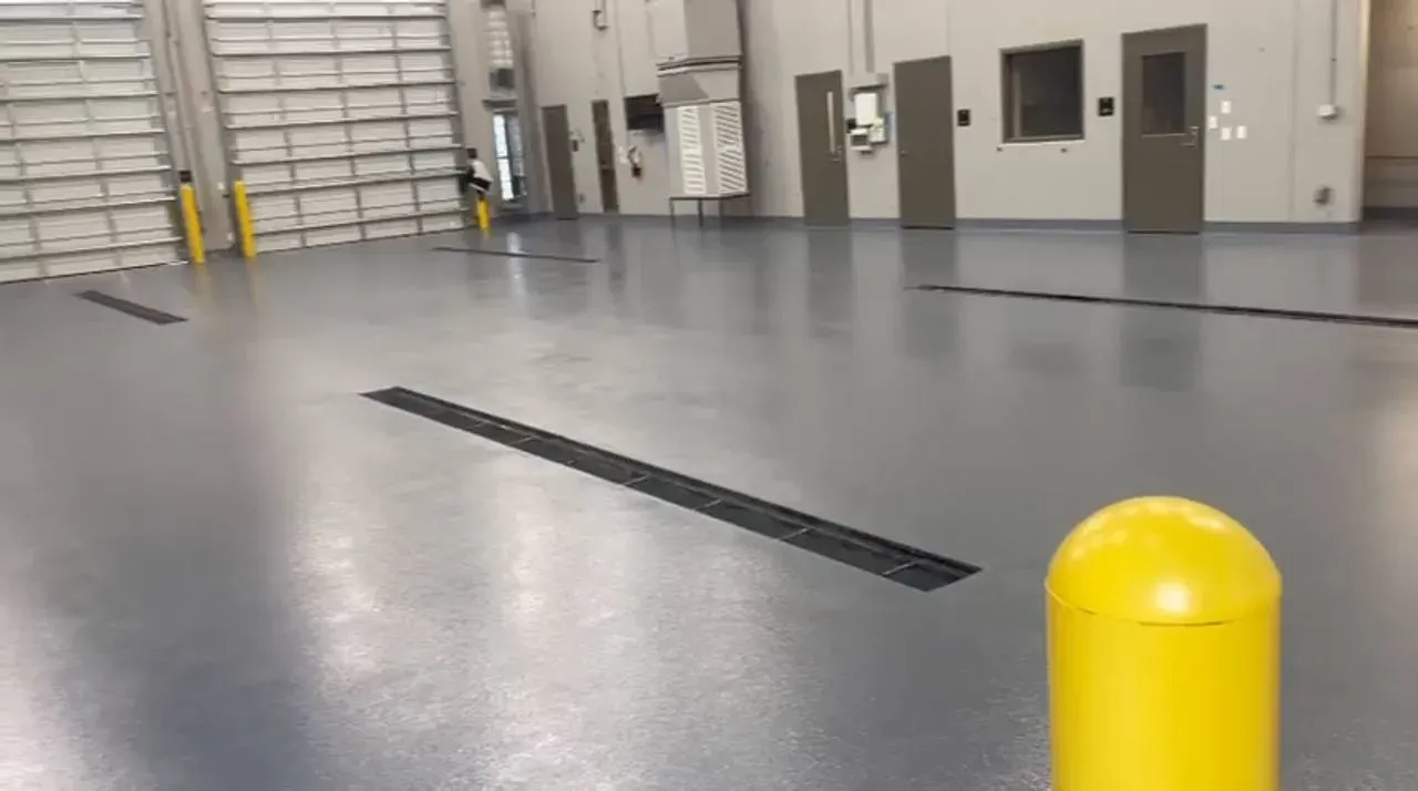 Light gray epoxy floor in a fleet maintenance bay
