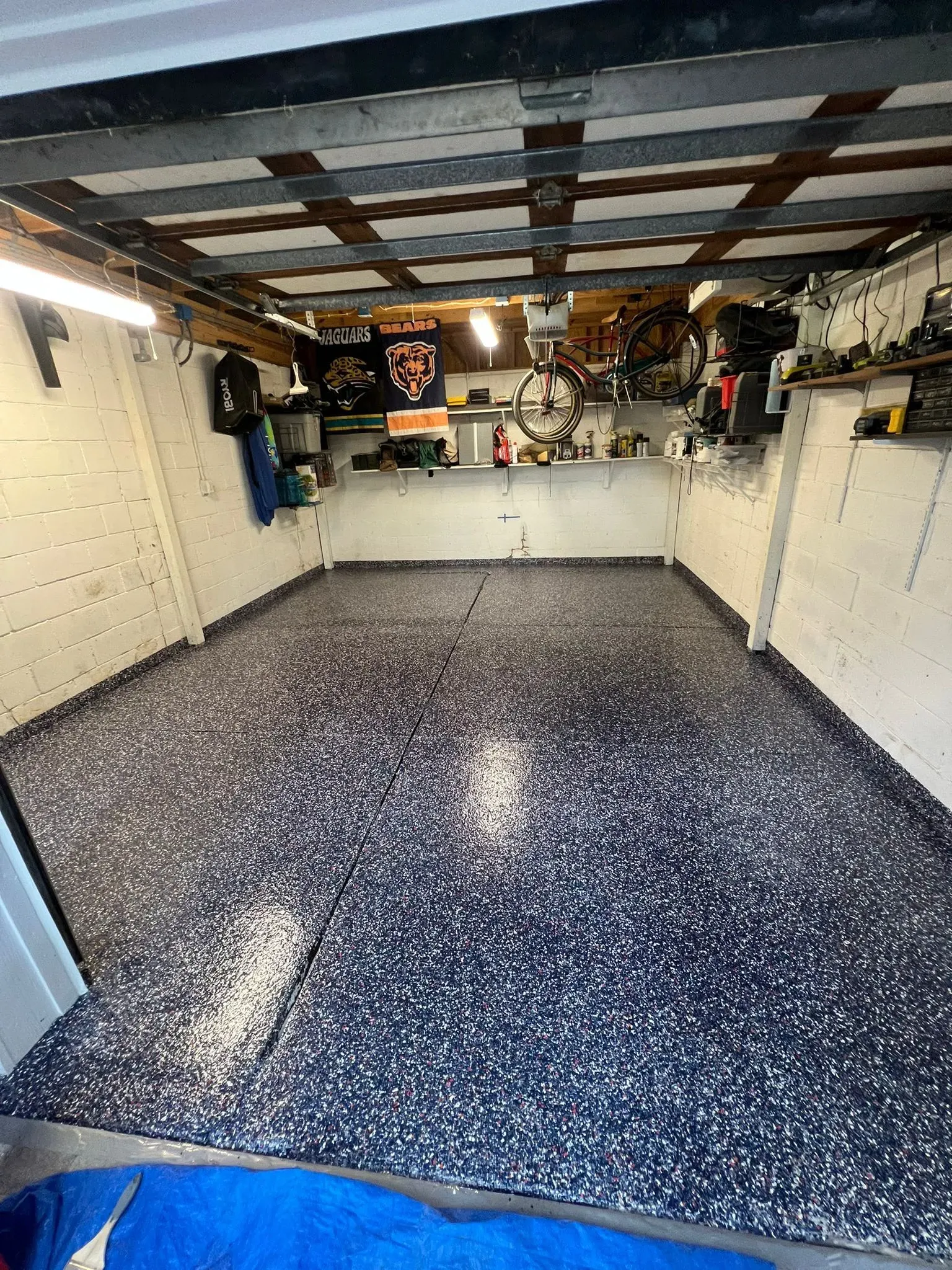 Residential garage with a dark blue flake epoxy floor